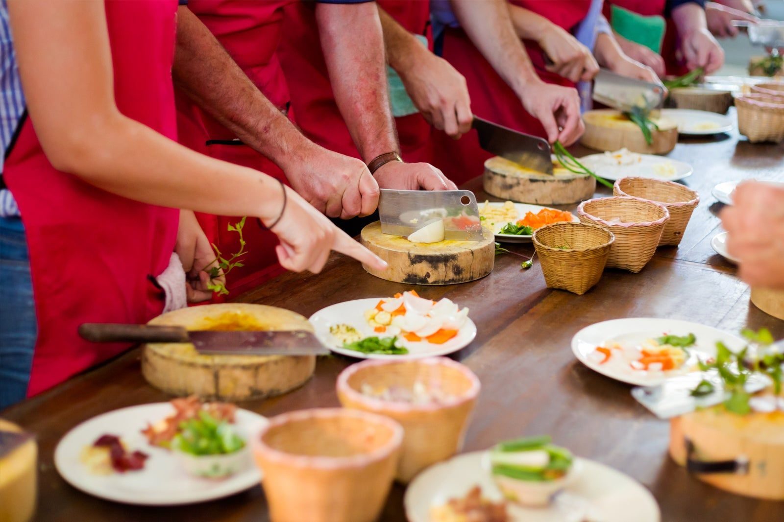 Pad Thai being stir-fried in a wok with fresh vegetables and tofu during a hands-on Thai cooking class