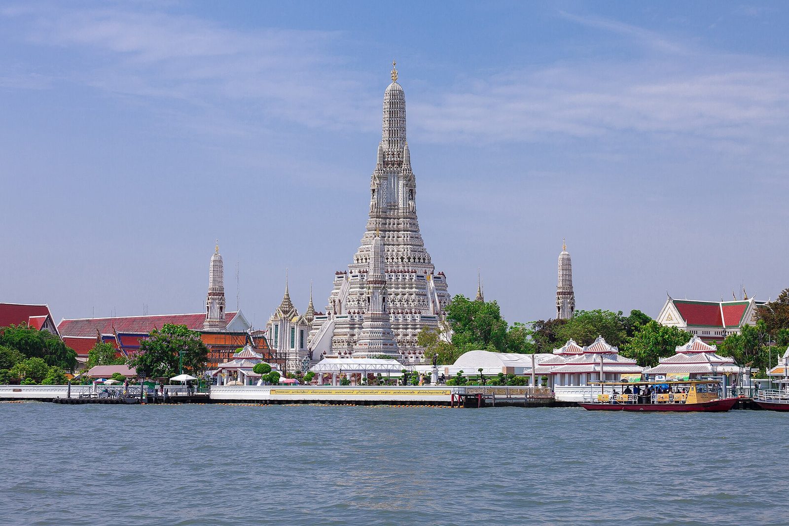 The iconic central prang of Wat Arun temple seen across the Chao Phraya River in Bangkok