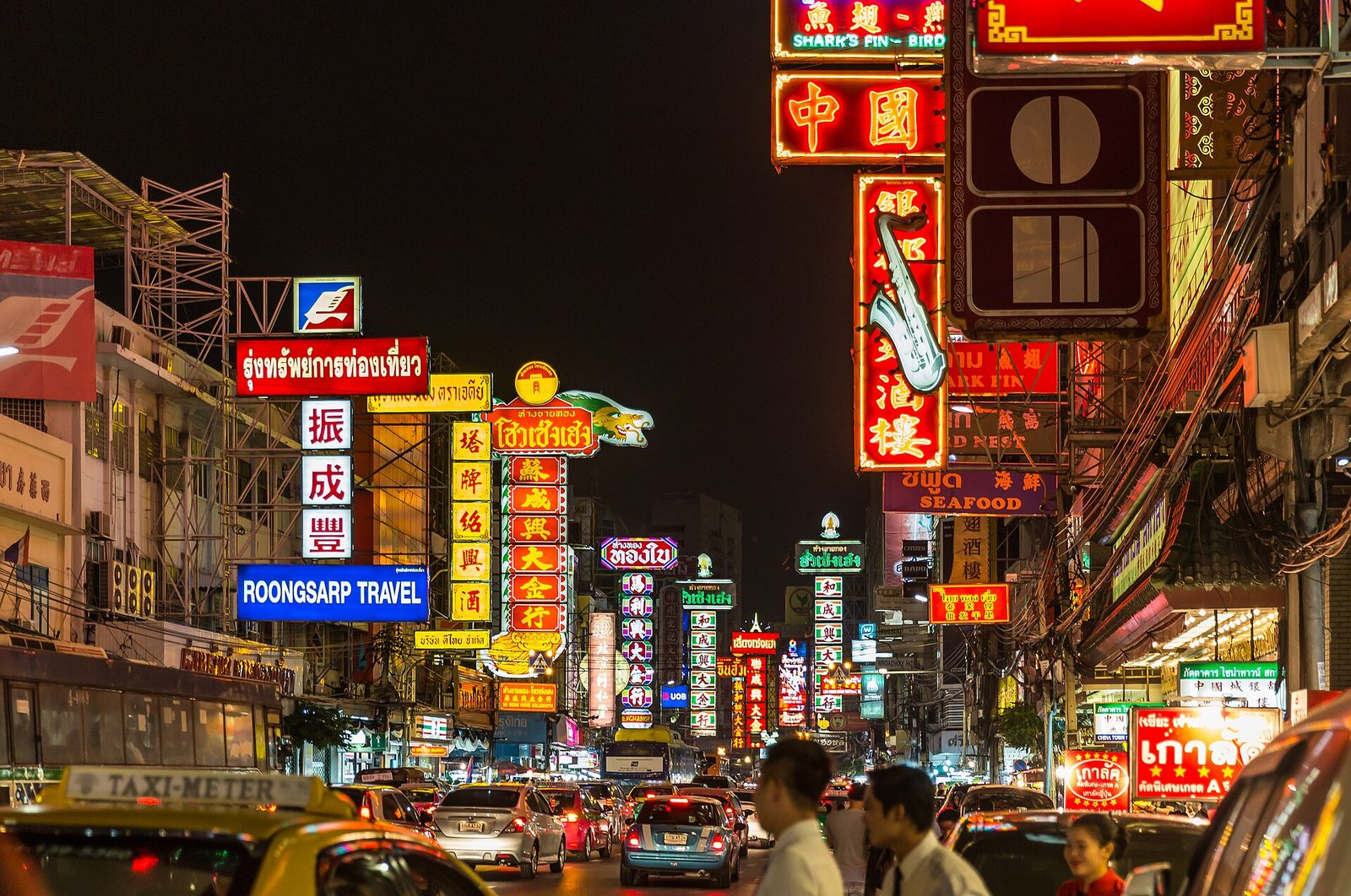 Neon signs and night traffic on Yaowarat Road in Bangkok's Chinatown